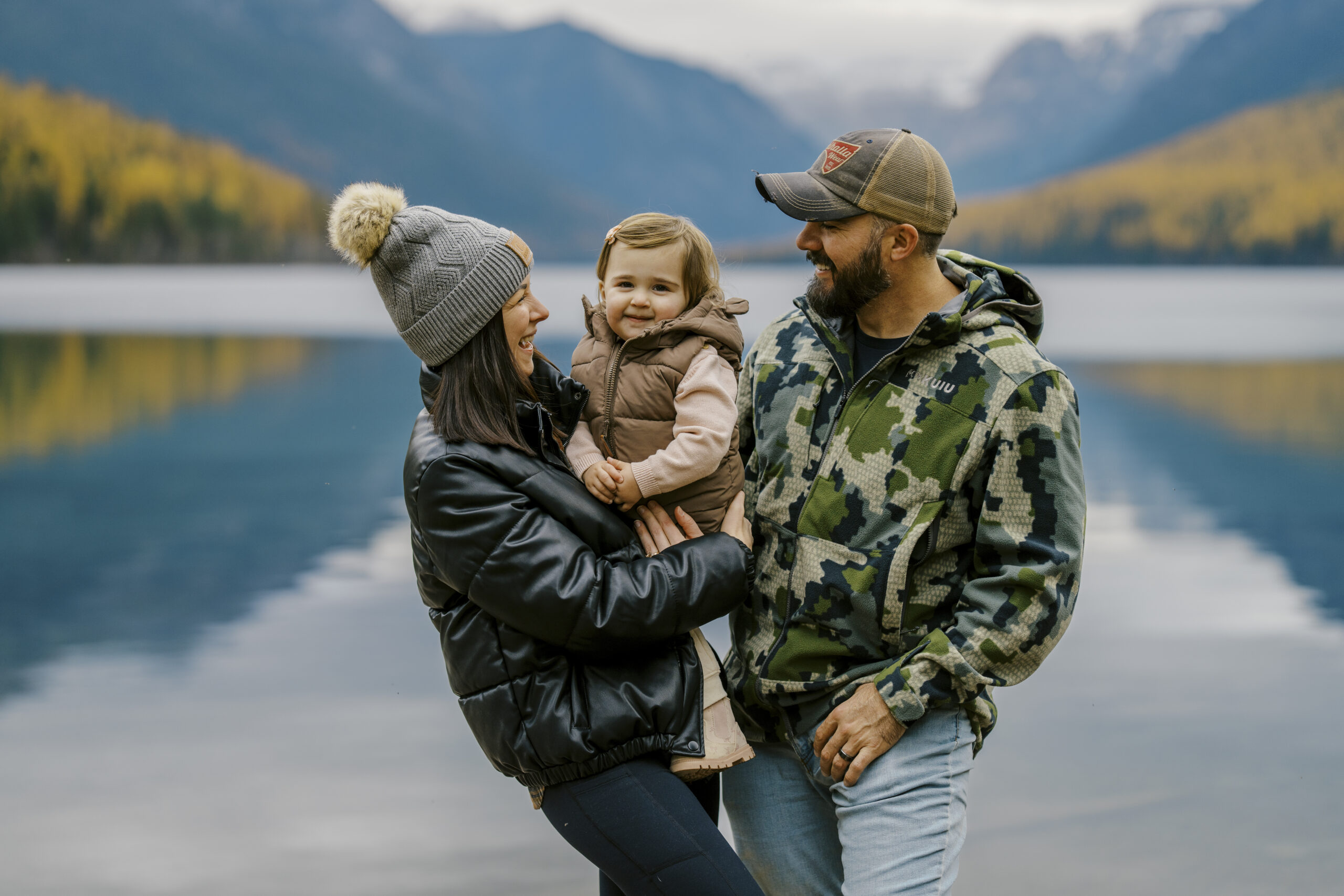 Couple at Bowman Lake in Glacier National Park with pristine glacial water and mountain peaks photographed by Joseph Mayden